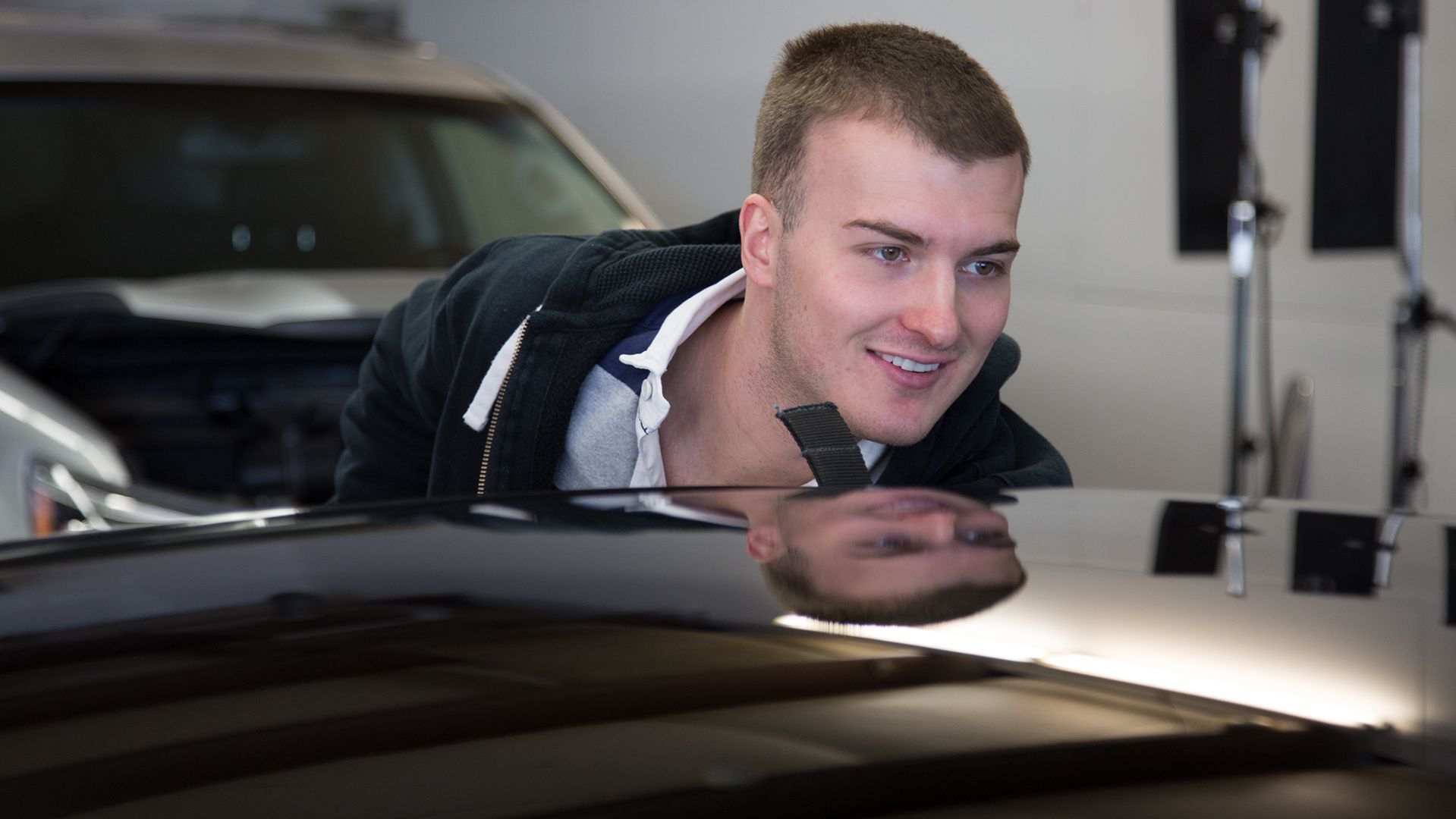 Superior Hail Repair technician inspecting paintless dent repair work.